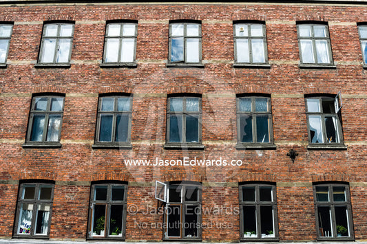 The facade and windows of a warehouse converted into apartments in Copenhagen. Copenhagen, Denmark.