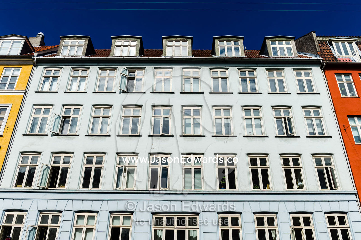 The colourful facades and windows of houses and apartments in Copenhagen. Copenhagen, Denmark.