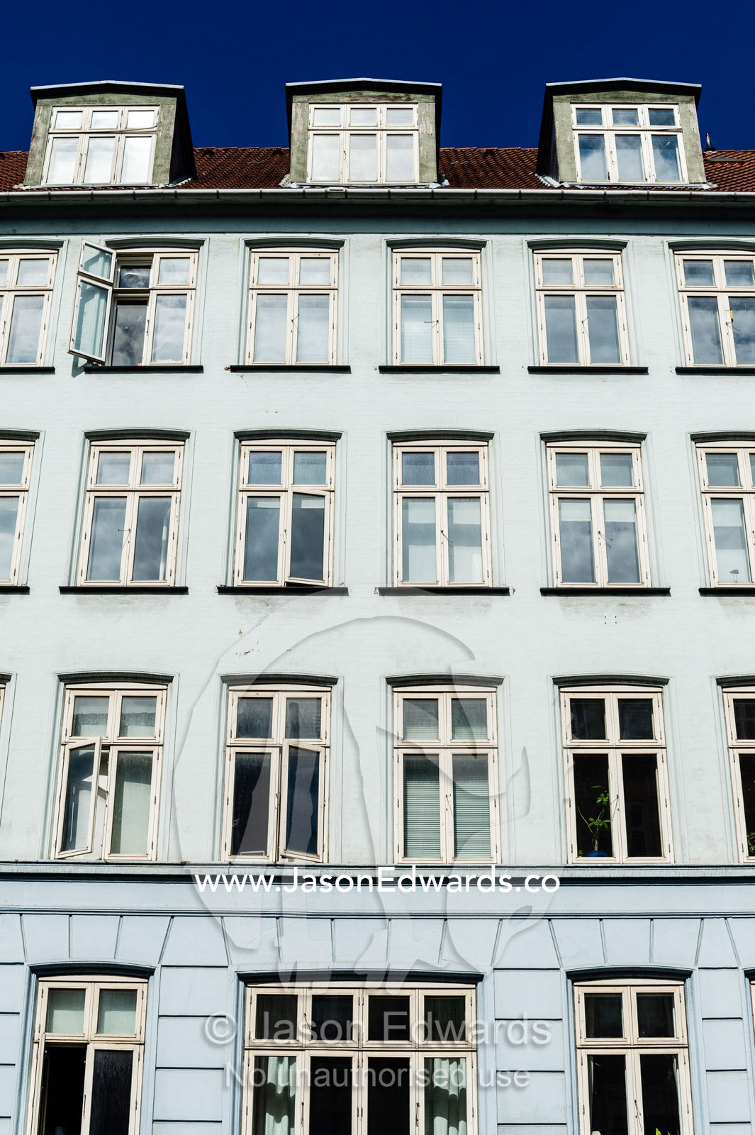 The colourful facades and windows of houses and apartments in Copenhagen. Copenhagen, Denmark.