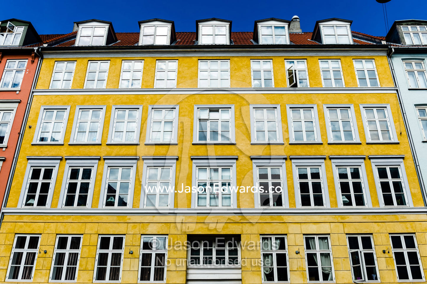 The colourful facades and windows of houses and apartments in Copenhagen. Copenhagen, Denmark.