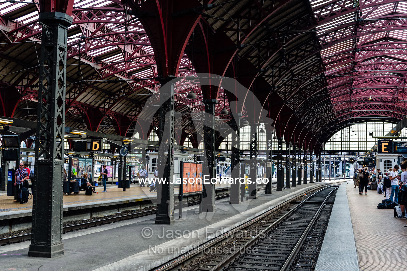 The steel and glass vaulted ceiling above a train platform. Copenhagen Central Train Station, Copenhagen, Denmark.