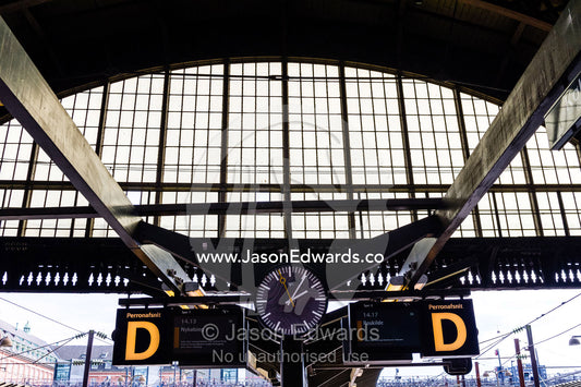 The steel and glass vaulted ceiling above a train platform. Copenhagen Central Train Station, Copenhagen, Denmark.