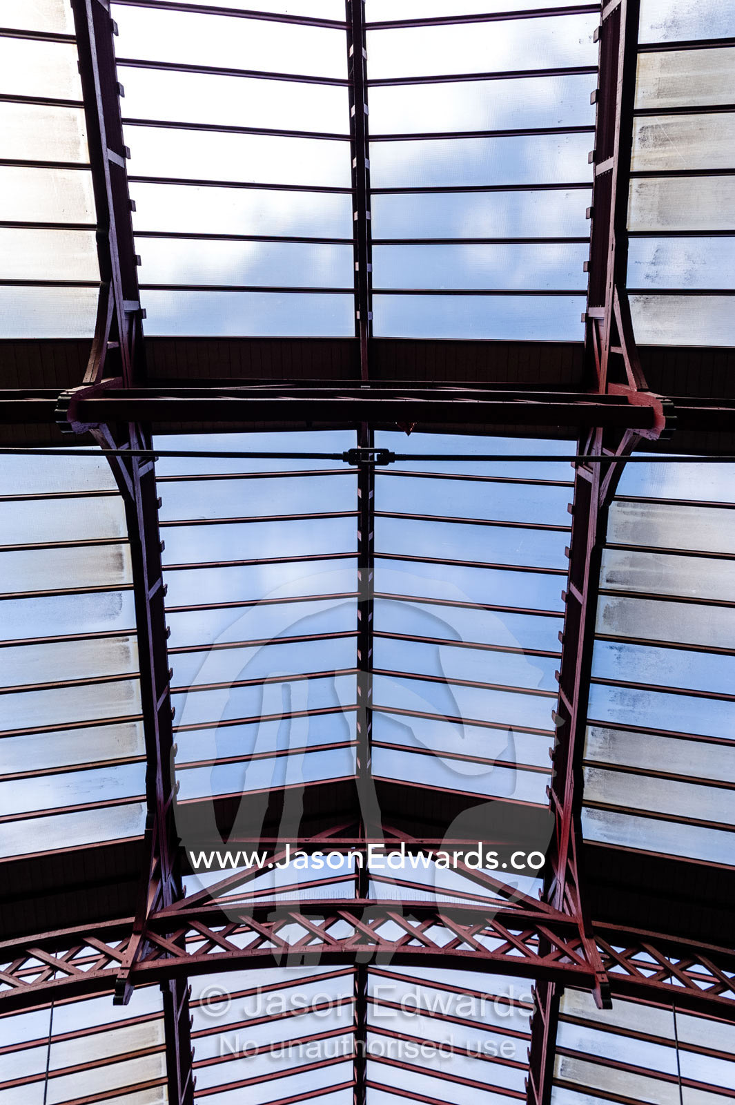 The steel and glass vaulted ceiling above a train platform. Copenhagen Central Train Station, Copenhagen, Denmark.