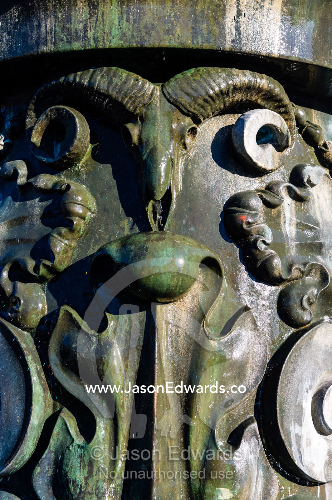 A bronze sculpture of a ram on a fountain in Copenhagen. Town Square, Copenhagen, Denmark.