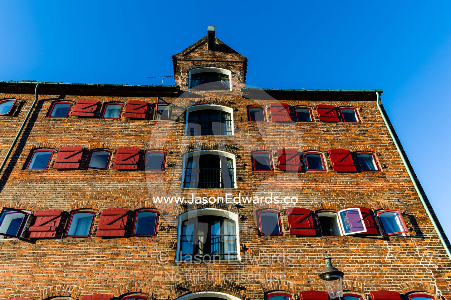 A storage warehouse conversion into apartments along a canal. Nyhavn Canal, Copenhagen, Hovedstaden Region, Denmark.