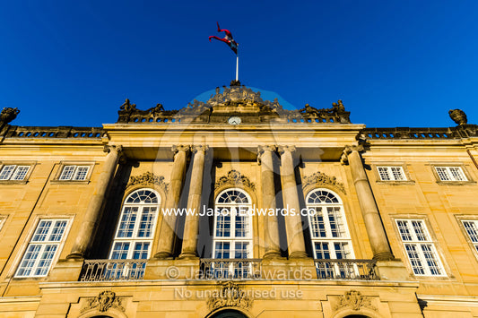 Sunset falls across window panes in the facade of the Royal Palace. Amalienborg Palace, Copenhagen, Denmark.
