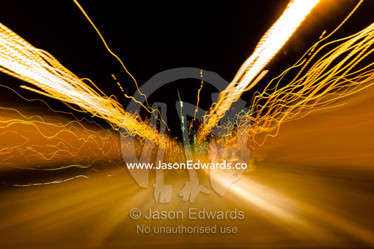 Blurred street lights and car headlights on a highway at night. near, Copenhagen Airport, Copenhagen, Denmark.