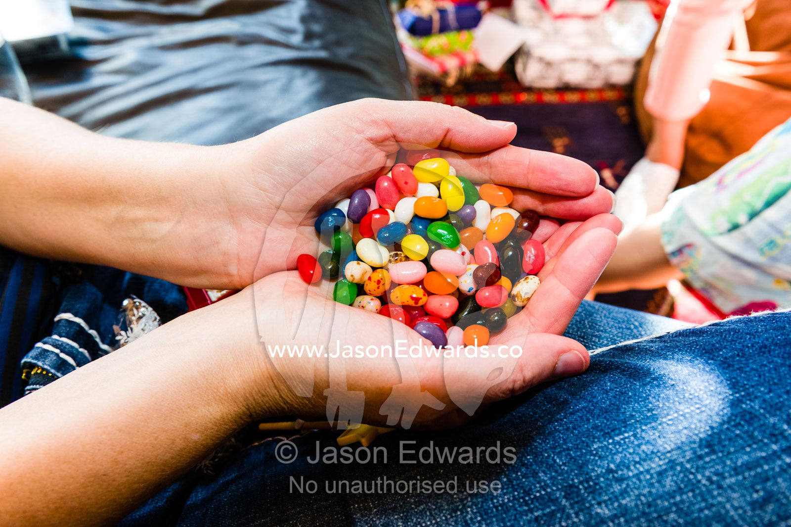 A handful of colourful jelly beans on Christmas day. East Malvern, Melbourne, Victoria, Australia.