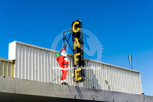 A Santa sign on a cafe facade in a rural town. Jerilderie, New South Wales, Australia.