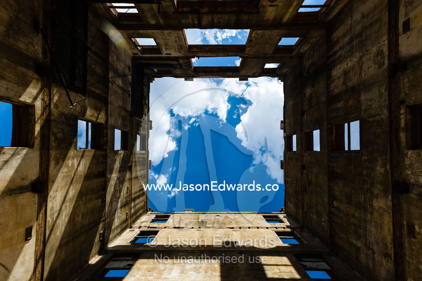 Sunlight enters the abandoned shell of an antique brewery in a rural town. Narrandera, New South Wales, Australia.