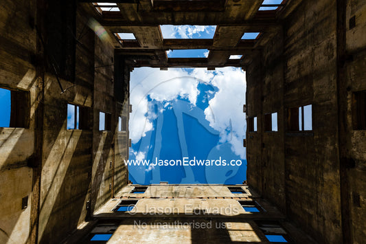 Sunlight enters the abandoned shell of an antique brewery in a rural town. Narrandera, New South Wales, Australia.
