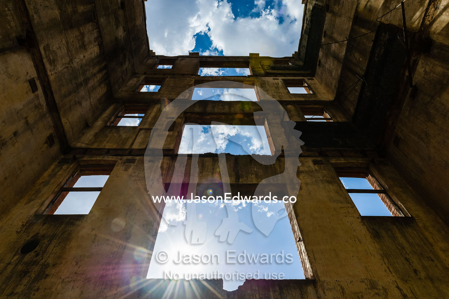 Sunlight enters the abandoned shell of an antique brewery in a rural town. Narrandera, New South Wales, Australia.