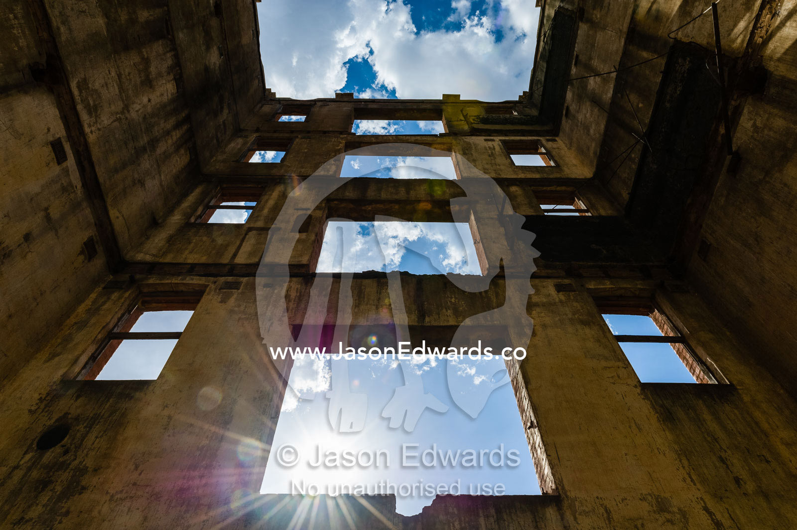 Sunlight enters the abandoned shell of an antique brewery in a rural town. Narrandera, New South Wales, Australia.
