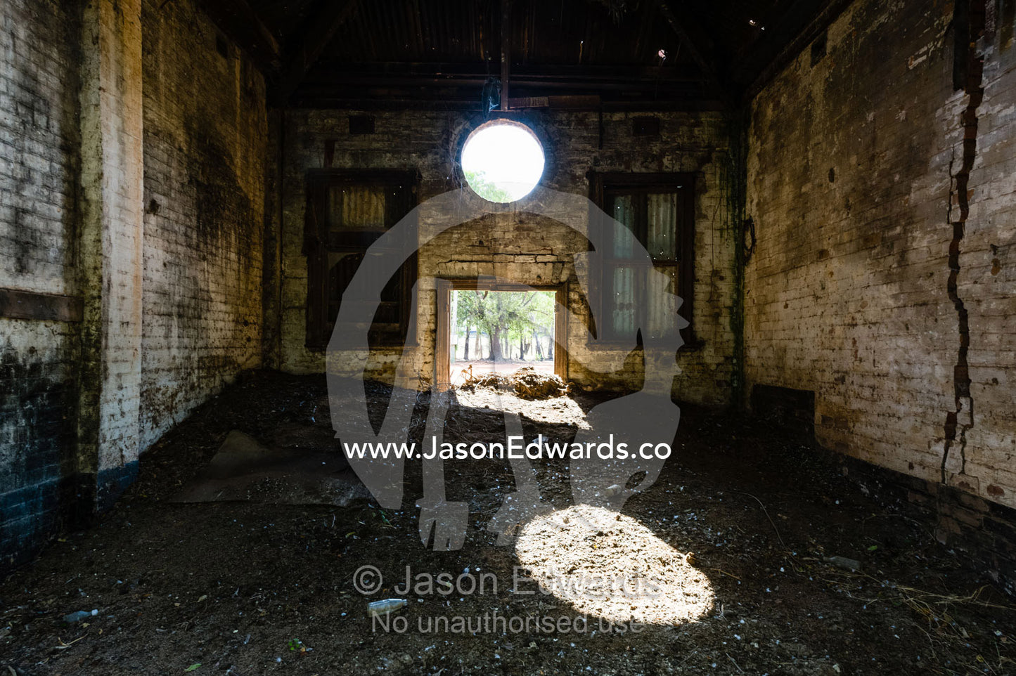 Sunlight enters the abandoned shell of an antique brewery in a rural town. Narrandera, New South Wales, Australia.
