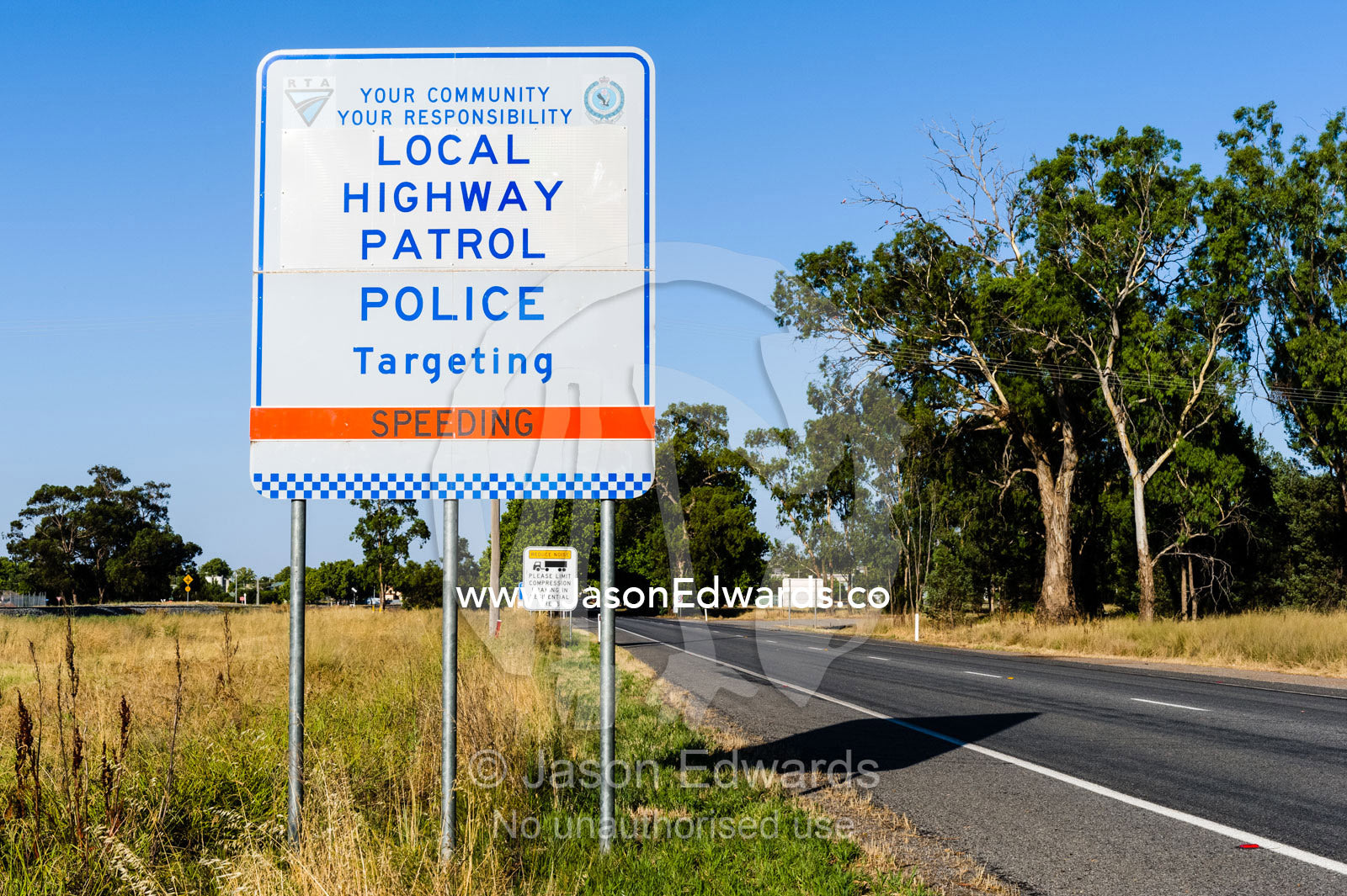 A police sign warning motorists to reduce there speed or face penalties. Narrandera, New South Wales, Australia.