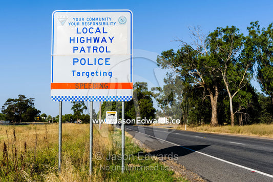 A police sign warning motorists to reduce there speed or face penalties. Narrandera, New South Wales, Australia.