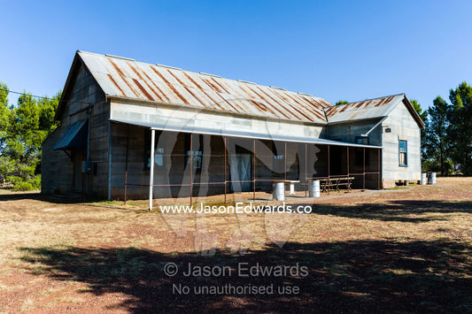 An abandoned antique corrugated tin house in a rural town. Mirrool, New South Wales, Australia.