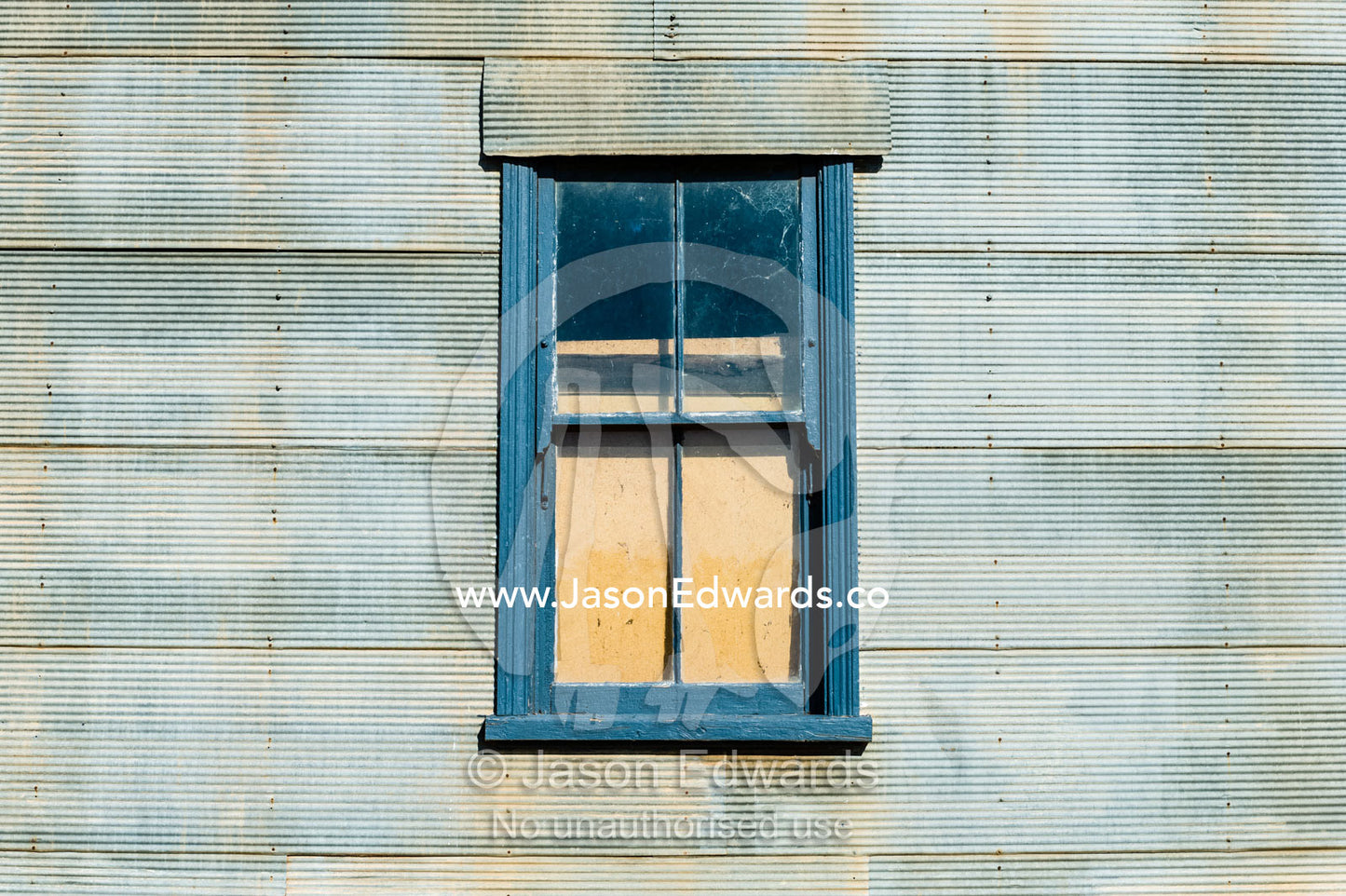 An abandoned antique corrugated tin house in a rural town. Mirrool, New South Wales, Australia.