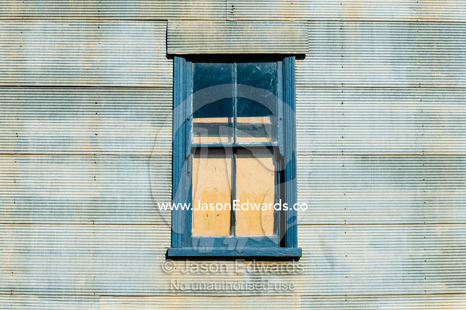 An abandoned antique corrugated tin house in a rural town. Mirrool, New South Wales, Australia.