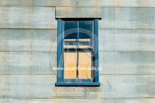 An abandoned antique corrugated tin house in a rural town. Mirrool, New South Wales, Australia.
