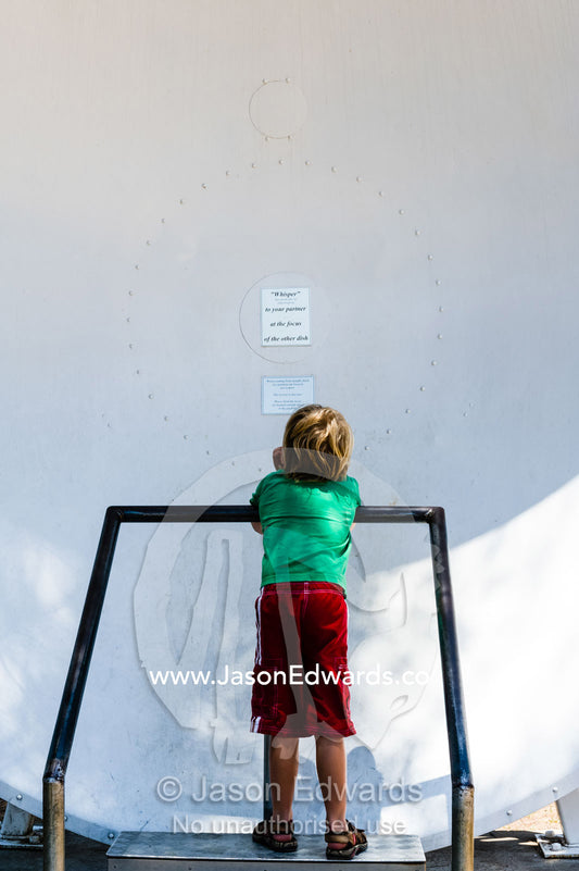 A child speaks into a whispering dish that carries the sound to another parabolic dish. CSIRO, Parkes Observatory, Australia National Telescope Facility, Parkes, New South Wales, Australia.