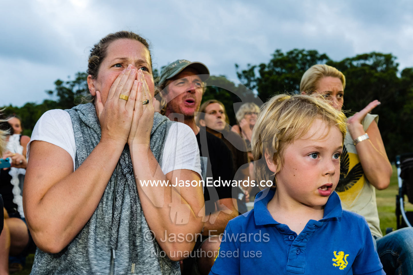 A woman gasps in horror after a cowboy is bucked off at a rodeo. Byron Bay, New South Wales, Australia.