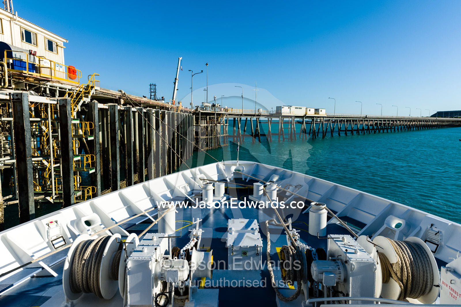 The winches on the bow of a cruise ship moored to a jetty. Broome, Kimberley Coast, Western Australia, Australia.