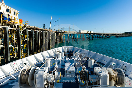 The winches on the bow of a cruise ship moored to a jetty. Broome, Kimberley Coast, Western Australia, Australia.