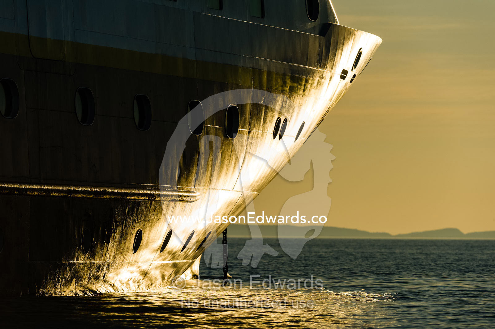 The bow of a cruise ship on a calm ocean at sunset. Doubtful Bay, Buccaneer Archipelago, Kimberley Coast, Western Australia, Australia.