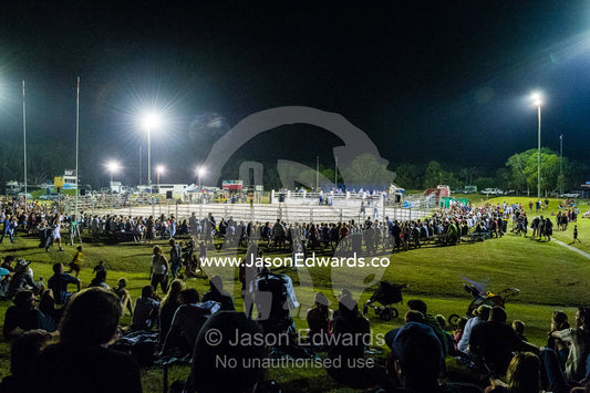 Crowds gather around an arena to watch a rodeo. Byron Bay, New South Wales, Australia.