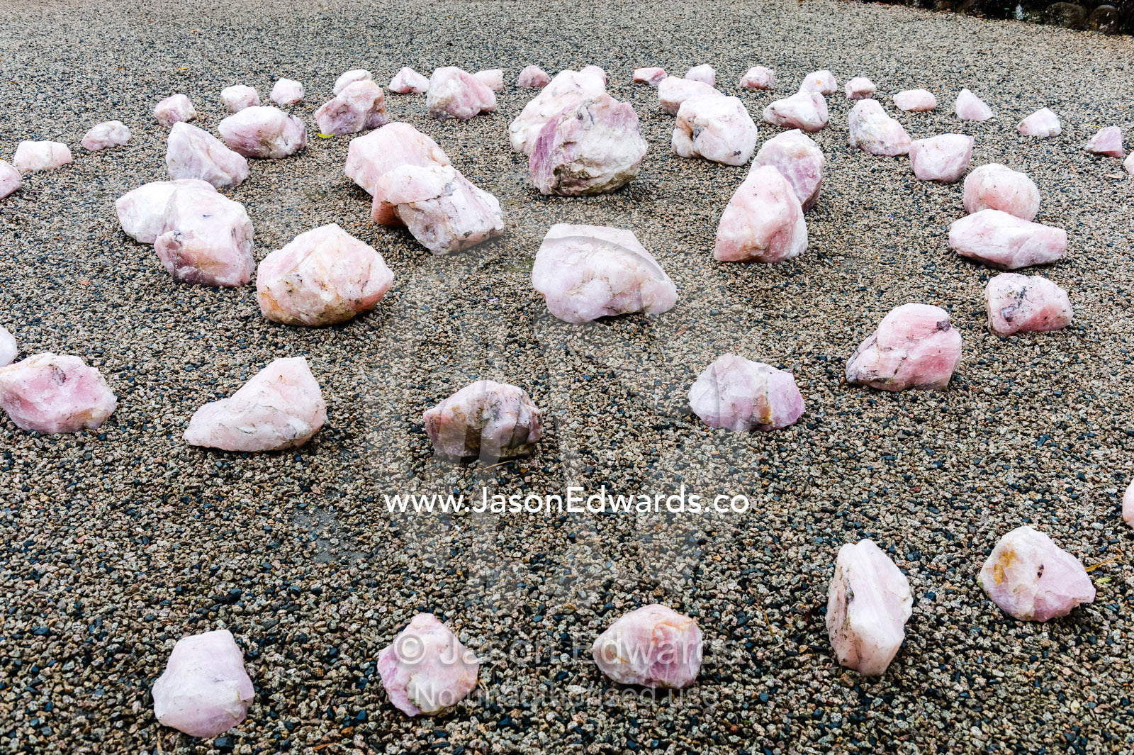 A spiral of rose quartz crystals in a botanical garden. Crystal Castle, Shambhala Gardens, Mullumbimby, New South Wales, Australia.