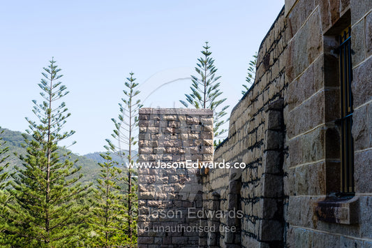 The tall limestone walls of an antique prison. Trial Bay Goal, Laggers Point, Arakoon National Park, New South Wales, Australia.