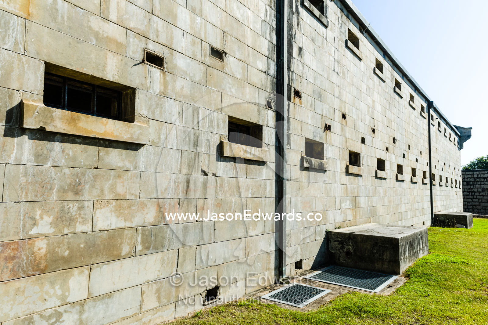 Small windows let in little light to prisoner cells in an antique prison. Trial Bay Goal, Laggers Point, Arakoon National Park, New South Wales, Australia.