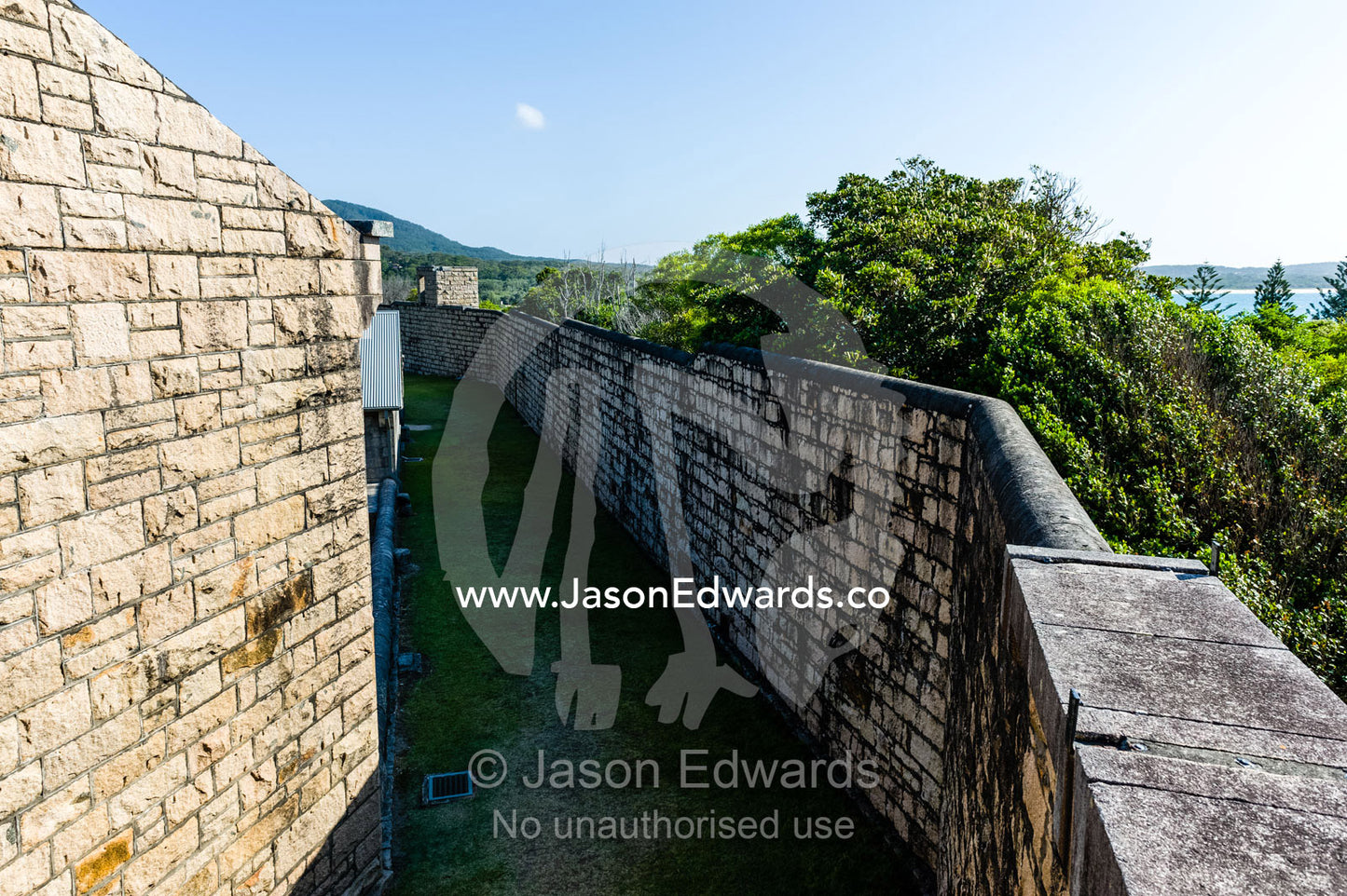 A high limestone moat wall prevented prisoners from escaping an antique prison. Trial Bay Goal, Laggers Point, Arakoon National Park, New South Wales, Australia.