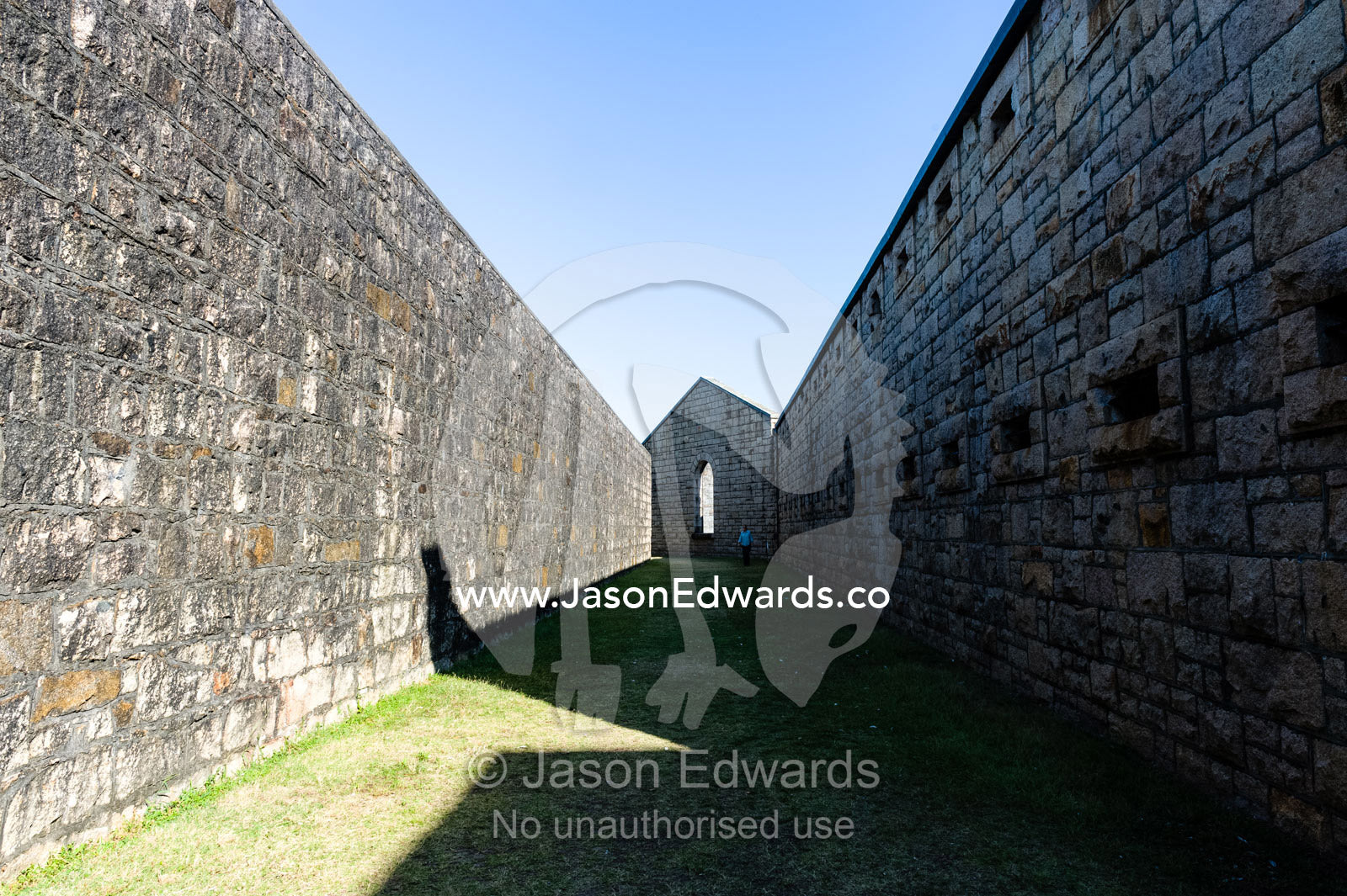 A high limestone moat wall prevented prisoners from escaping an antique prison. Trial Bay Goal, Laggers Point, Arakoon National Park, New South Wales, Australia.