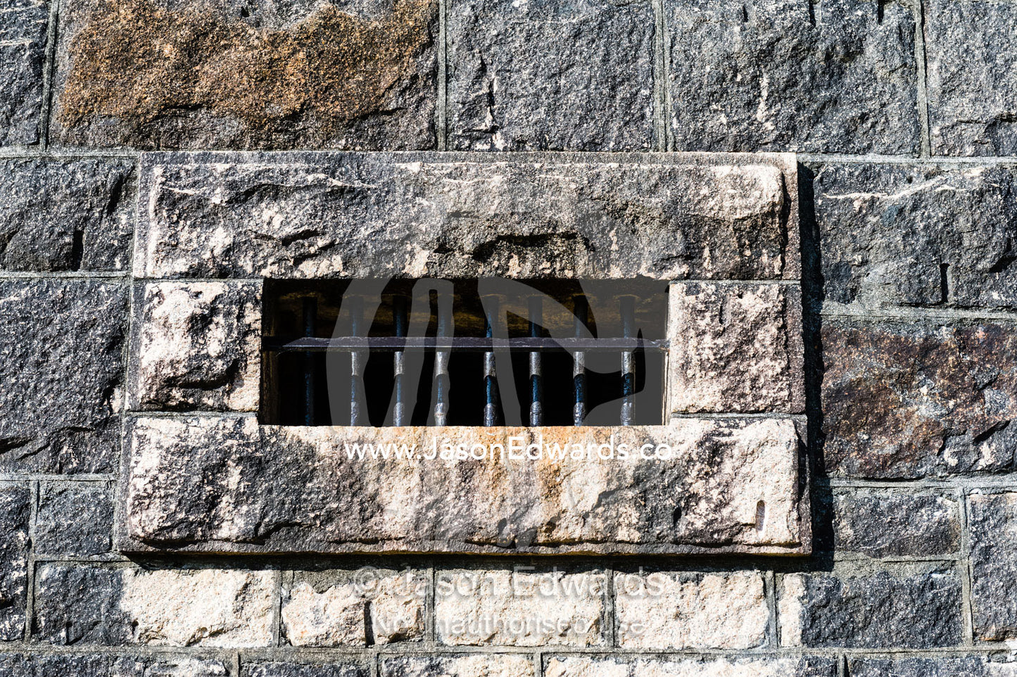 Steel bars in a limestone wall of an antique prison. Trial Bay Goal, Laggers Point, Arakoon National Park, New South Wales, Australia.