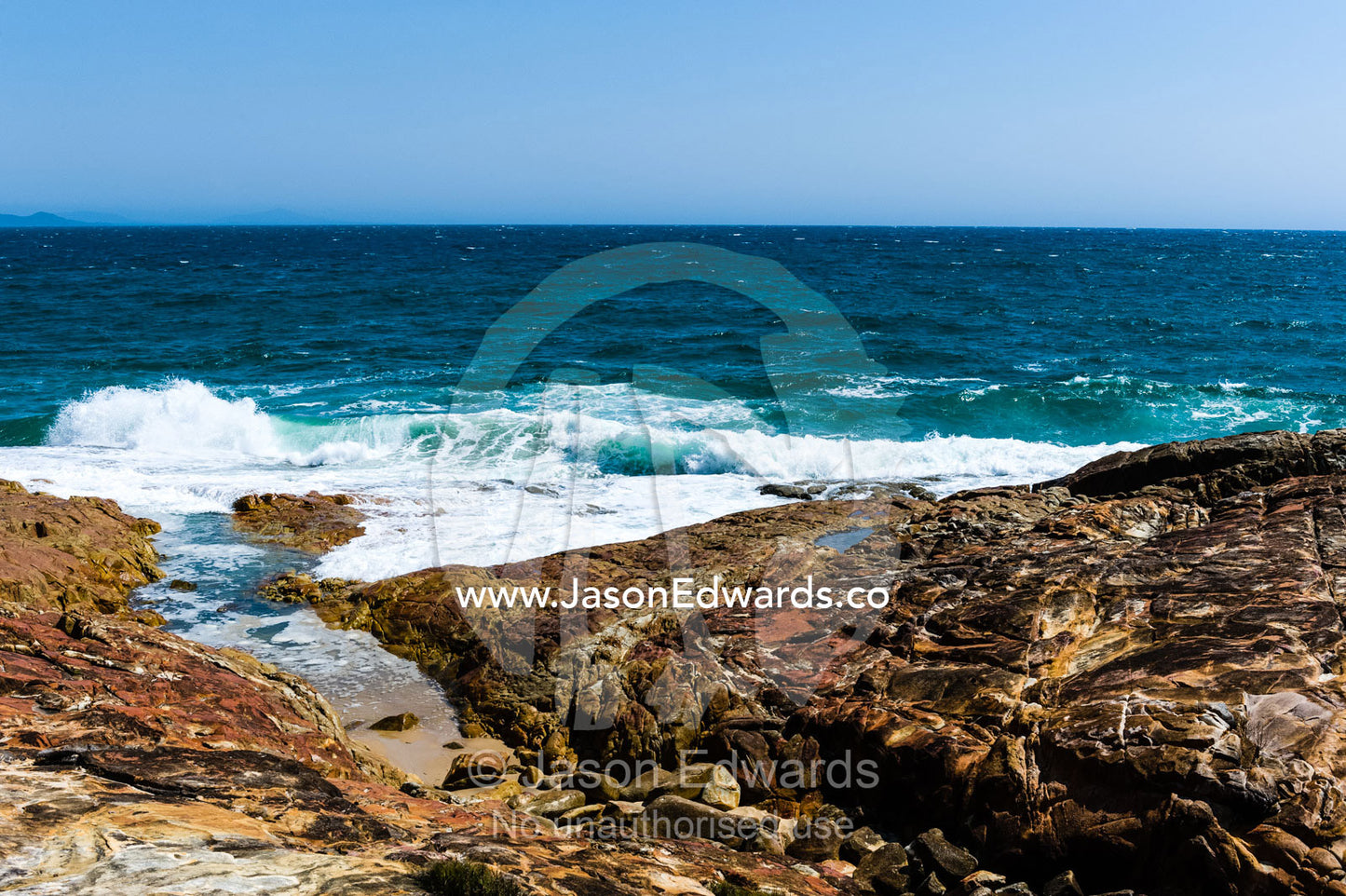 Waves breaking on a rocky headland. South West Rocks, New South Wales, Australia.