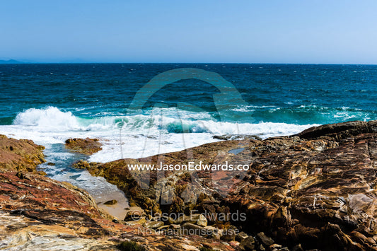 Waves breaking on a rocky headland. South West Rocks, New South Wales, Australia.