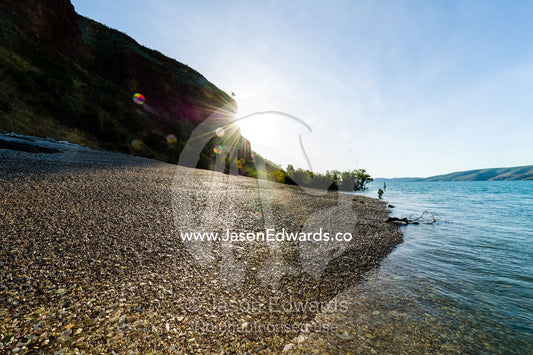 Sunlight reflecting off a shale beach on a desert island. Slug Island, Buccaneer Archipelago, Kimberley Coast, Western Australia, Australia.