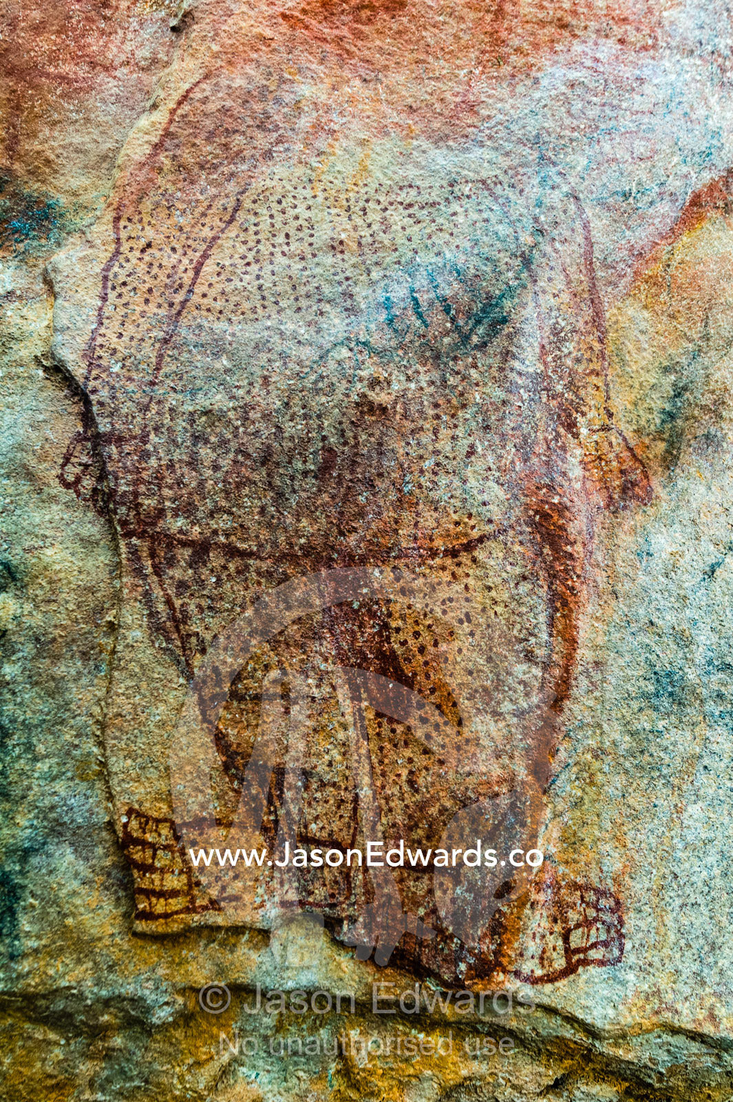 An ancient Wandjina painting featuring a man on the wall of a cave. Raft Point, Doubtful Bay, Buccaneer Archipelago, Kimberley Coast, Western Australia, Australia.