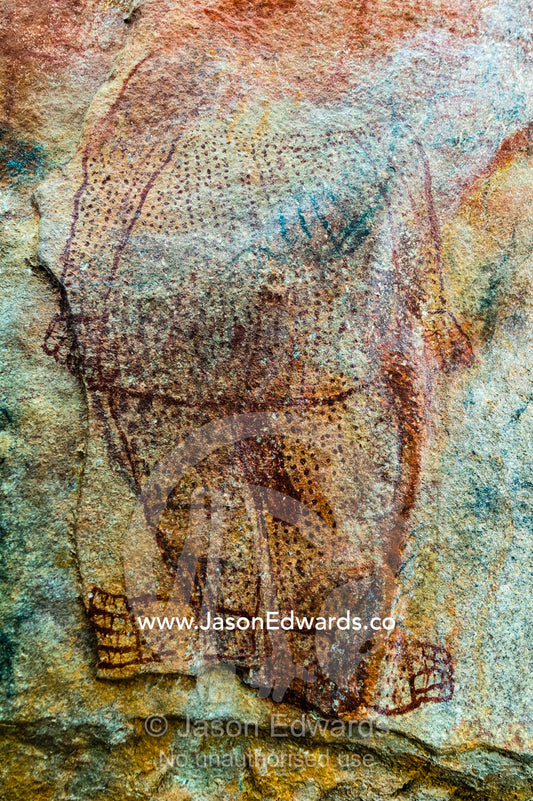 An ancient Wandjina painting featuring a man on the wall of a cave. Raft Point, Doubtful Bay, Buccaneer Archipelago, Kimberley Coast, Western Australia, Australia.