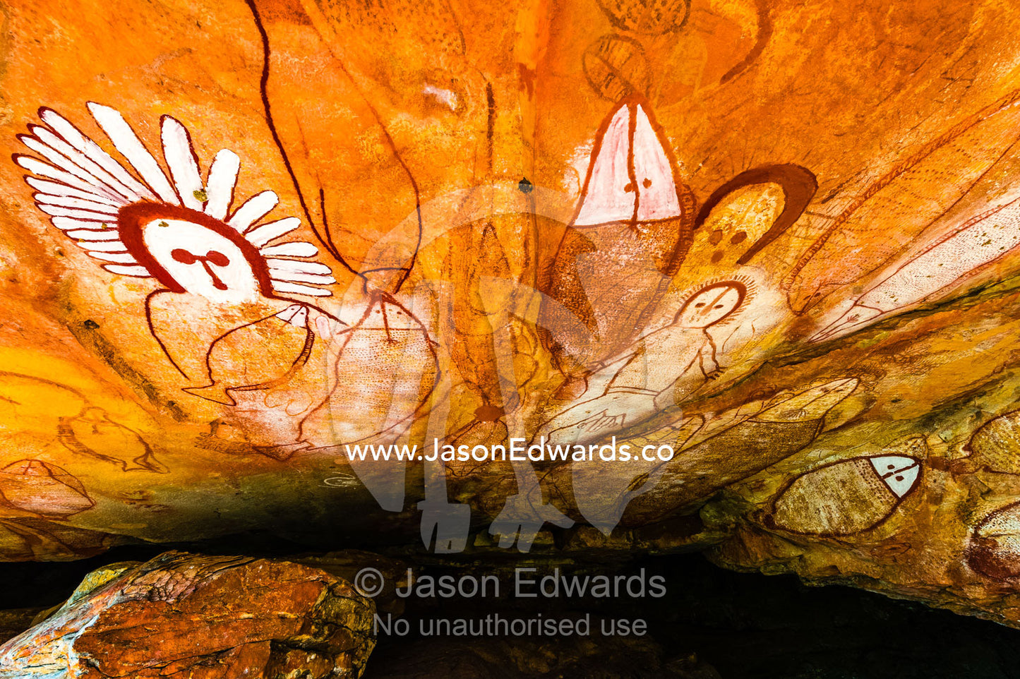 The rich ochre colours of an Aboriginal rock painting gallery featuring The Great Fish Chase. Raft Point, Doubtful Bay, Buccaneer Archipelago, Kimberley Coast, Western Australia, Australia.