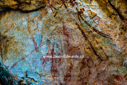 Ancient Aboriginal Gwion Gwion rock paintings also know as Bradshaw rock art featuring figures estimated at 50,000 years old on a cave wall. Jar Island, Vansittart Bay, Kimberley Coast, Western Australia, Australia.