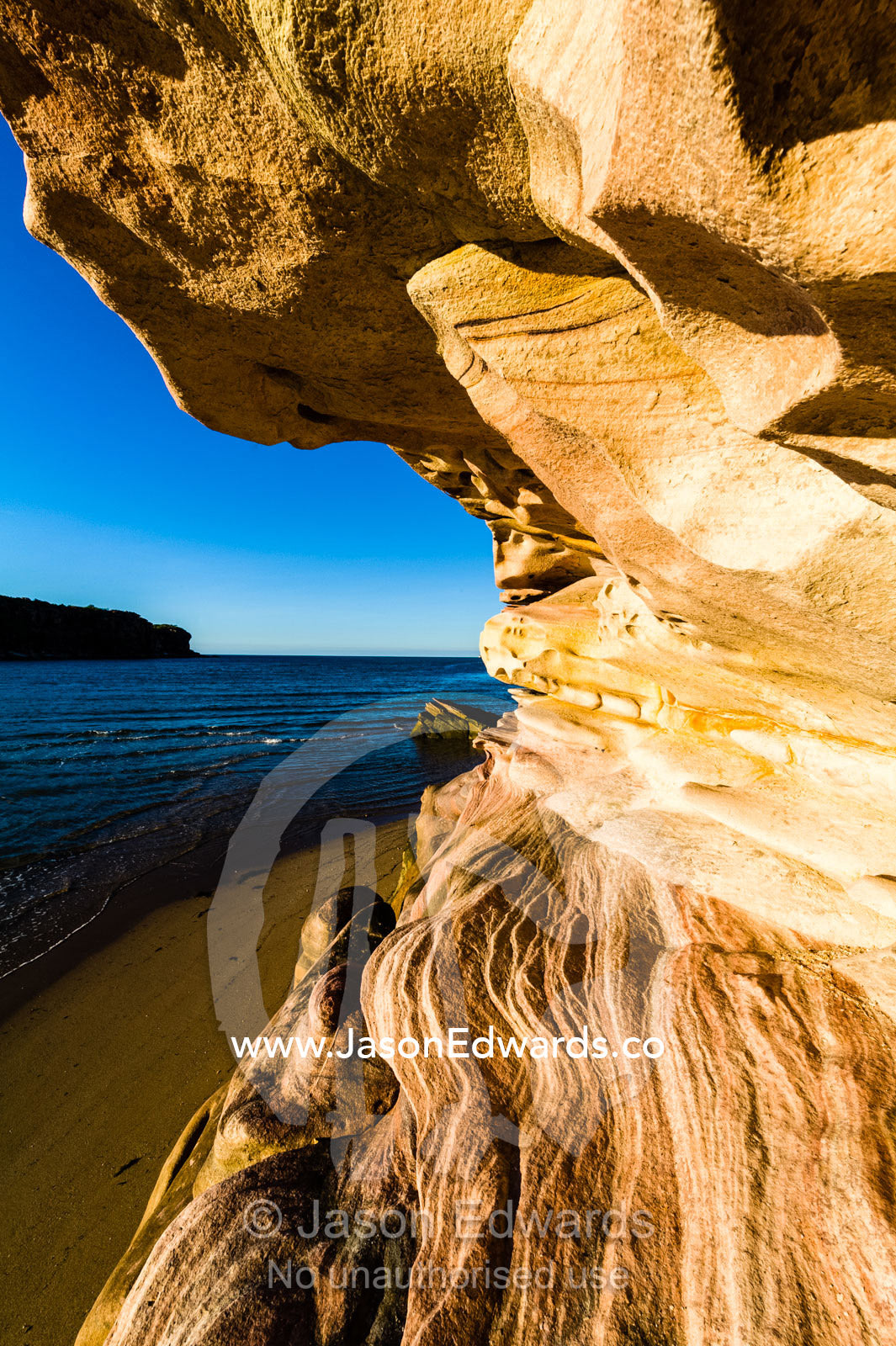 Late afternoon sunlight on waves of sandstone overlooking the ocean. Calamity Bay, Koolama Bay, Kimberley Coast, Western Australia, Australia.