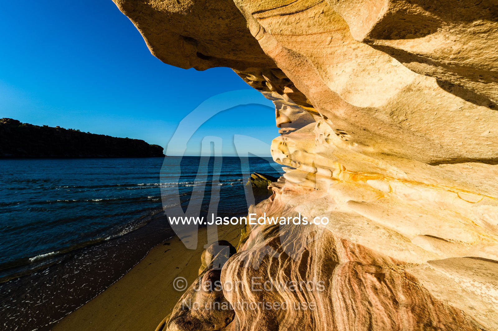 Late afternoon sunlight on waves of sandstone overlooking the ocean. Calamity Bay, Koolama Bay, Kimberley Coast, Western Australia, Australia.
