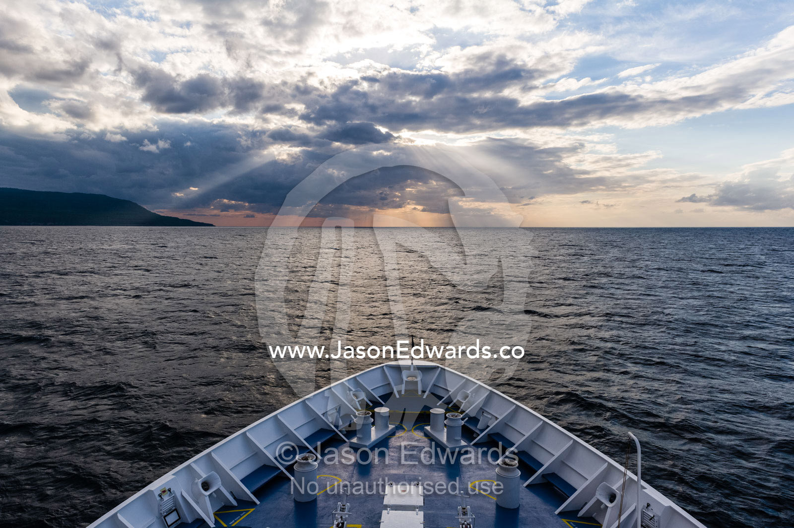 The bow of a cruise ship approaching a tropical island. Joseph Bonaparte Gulf, Bonaparte Gulf, Com, Sunda Islands, Timor-Leste, East Timor.
