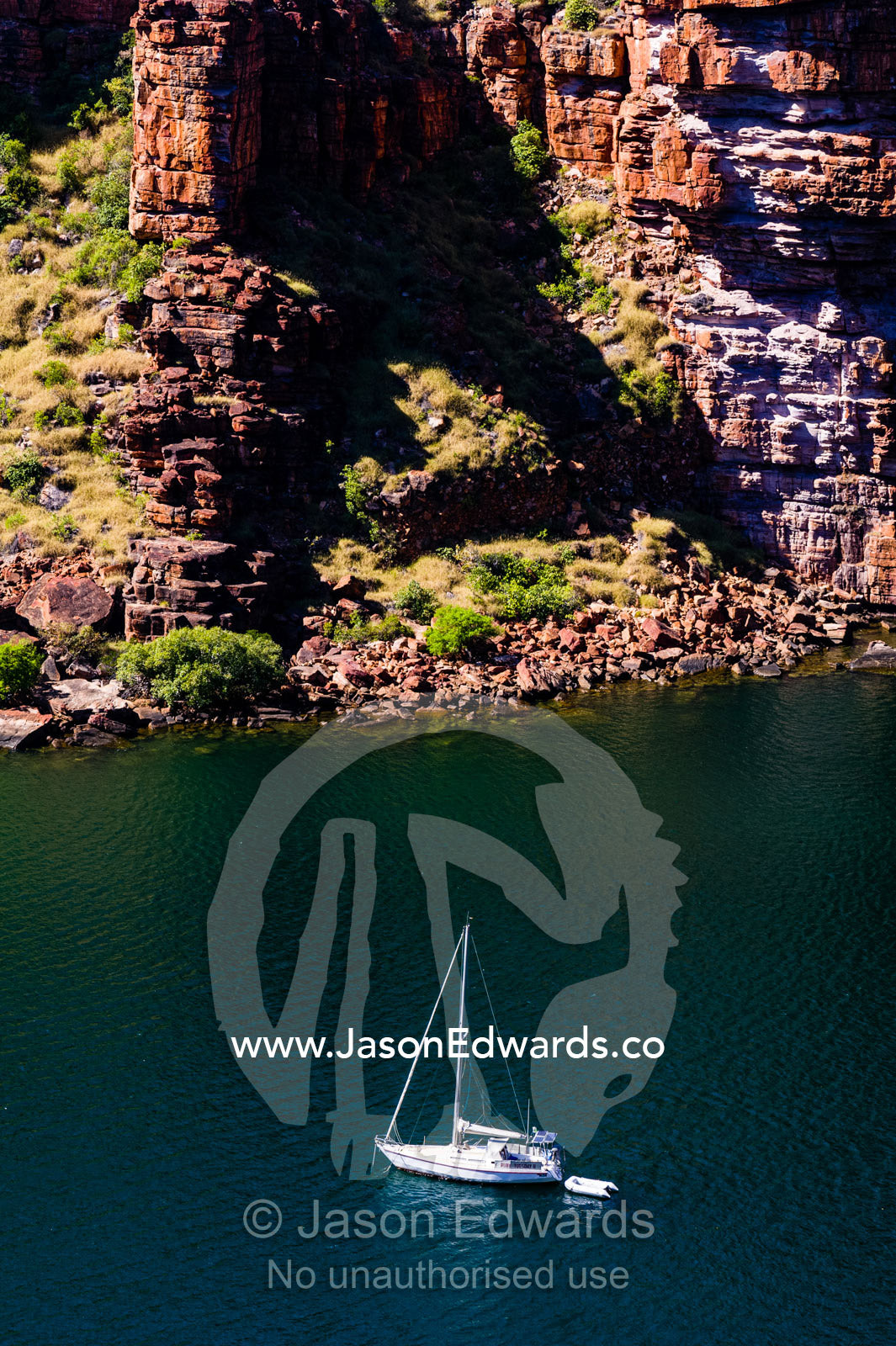 A yacht exploring in a remote desert canyon. King George River, King George Falls, Gardner Plateau, Kimberley Coast, Western Australia, Australia.