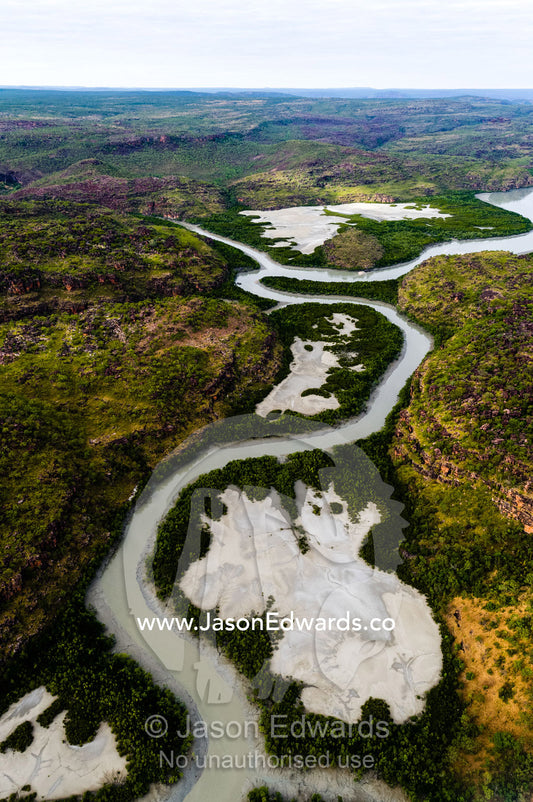 An aerial view of river tidal inlets winding their way through mangrove forests. Mitchell River National Park, Mitchell Plateau, Kimberley Coast, Western Australia, Australia.