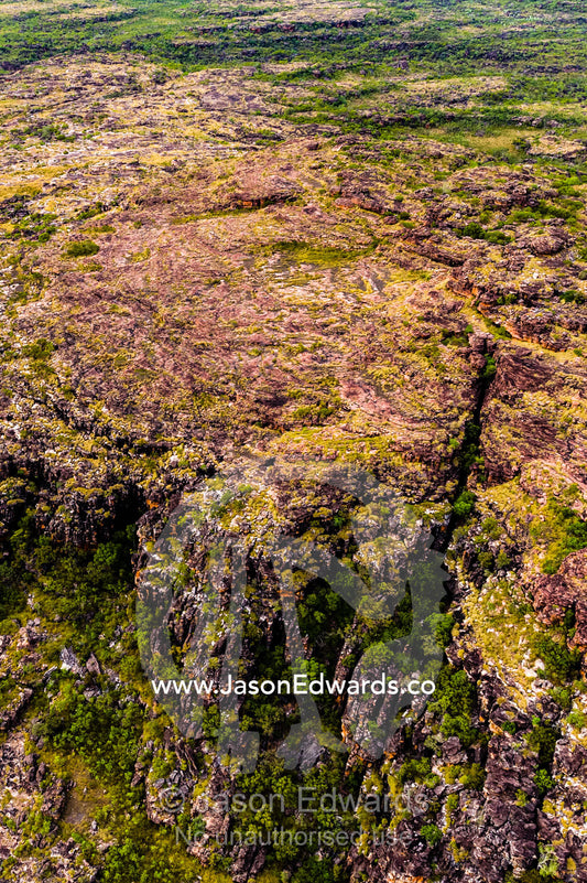 An aerial view of the harsh rocky surface of an arid plateau on the Kimberley coastline. Mitchell River National Park, Mitchell Plateau, Kimberley Coast, Western Australia, Australia.