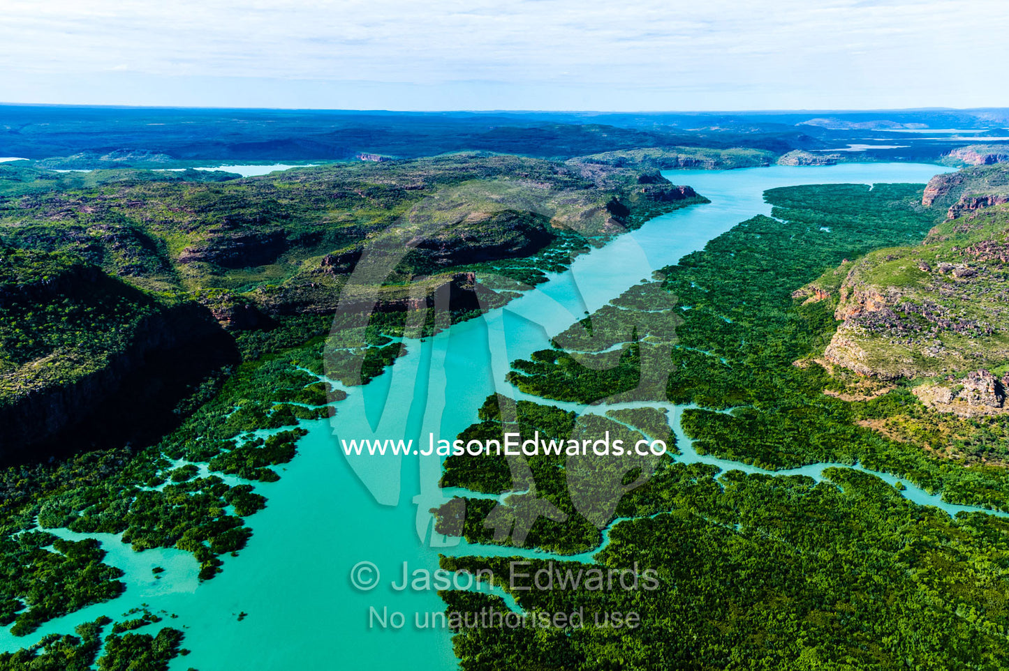An aerial view of river tidal inlets winding their way through mangrove forests. Porosus Creek, Hunter River, Mitchell River National Park, Mitchell Plateau, Kimberley Coast, Western Australia, Australia.